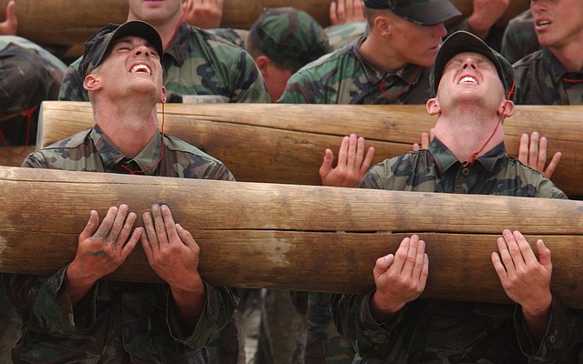 Men lifting a heavy log.