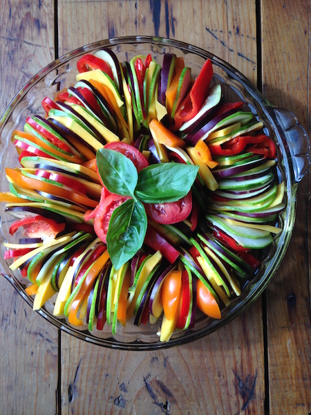 This Rainbow Ratatouille is just as delicious as it is beautiful. Made with fresh tomatoes and layered vegetables as pictured in this photo. 