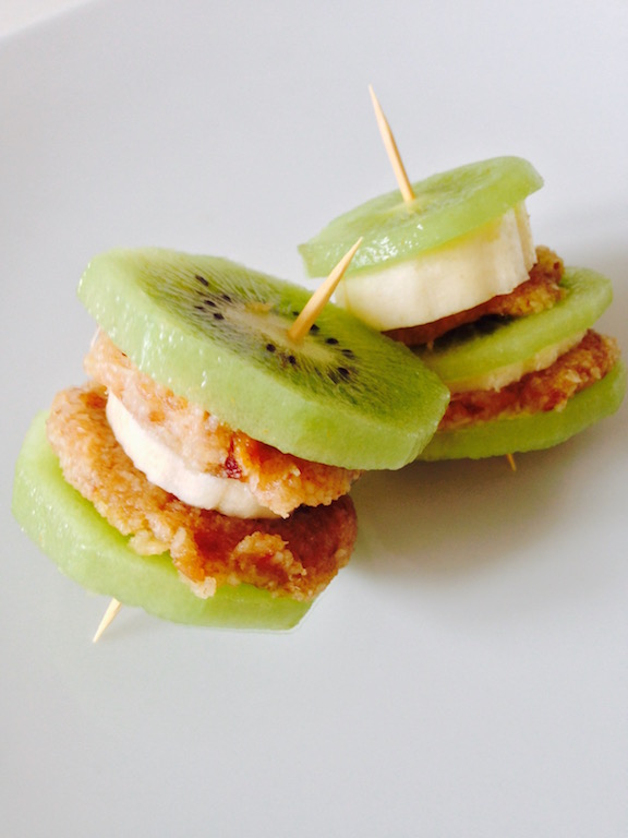 Very easy and cute, these Kiwi Banana Stacks are made a coconut "icing" and sliced banana sandwiched between two slices of fresh kiwi, as shown in this photograph. 